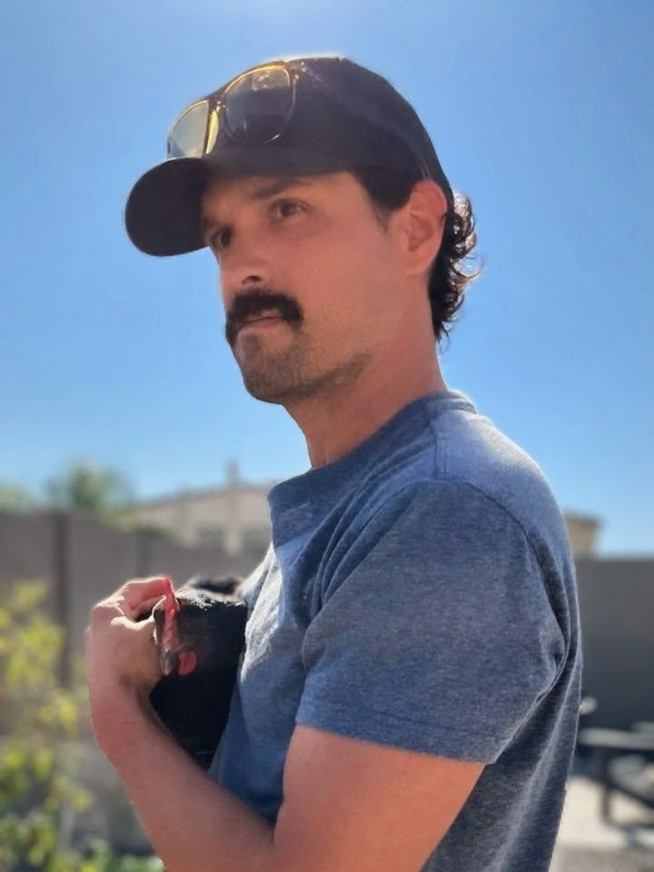 Steven Hernandez in a ball cap and blue T-shirt, outdoors in Phoenix